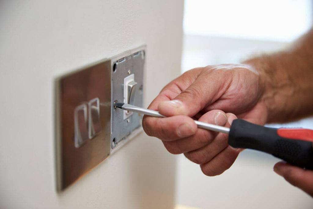 person fixing a light